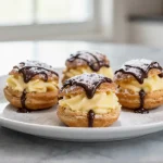 Délicieuses profiteroles au Cookeo, garnies de crème et recouvertes de chocolat